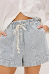Striped shorts with a drawstring worn by a person on a plain background