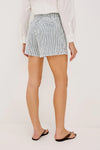 Person wearing a white shirt and striped shorts on a plain background