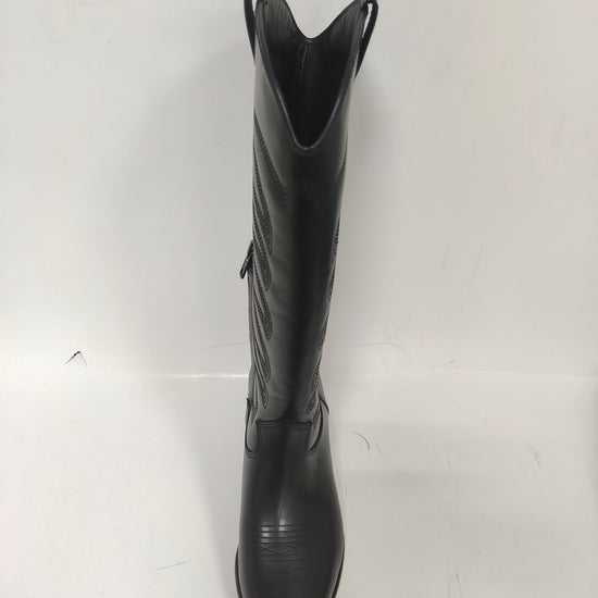 Tall black cowboy boots with quilted details on the shaft