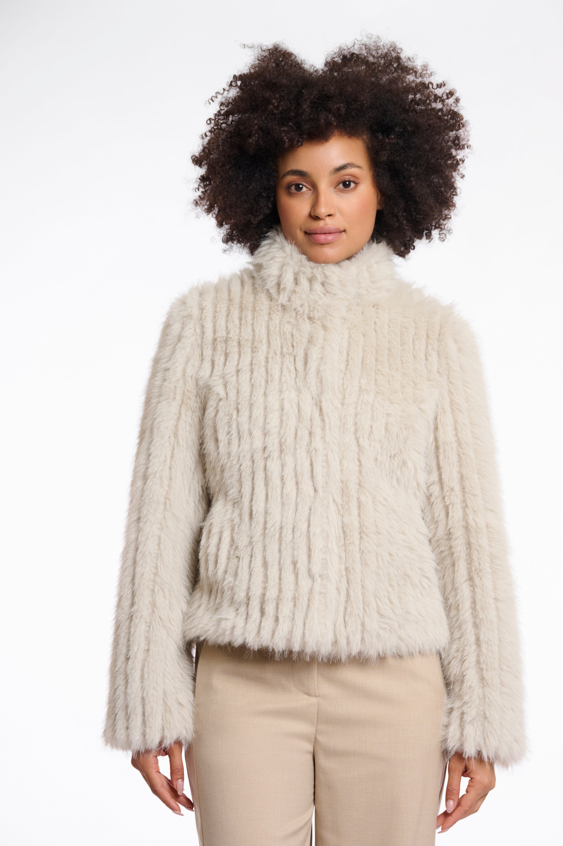 beige faux fur jacket with high neck, central closure and stripe detailing in the fur