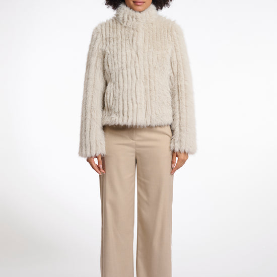 beige faux fur jacket with high neck, central closure and stripe detailing in the fur model shot 