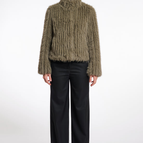 green faux fur jacket with central closure, high neck and stripe detailing in the fur model shot