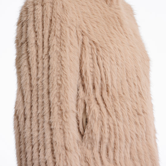 light beige faux fur jacket with high neck, central closure and stripe detailing in the fur side view 