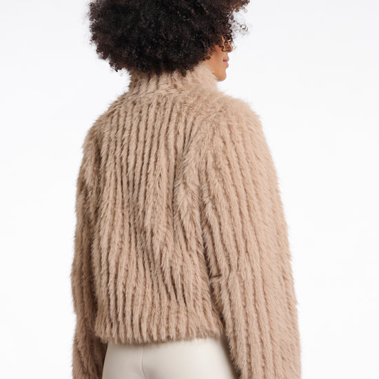  light beige faux fur jacket with high neck, central closure and stripe detailing in the fur rear view 