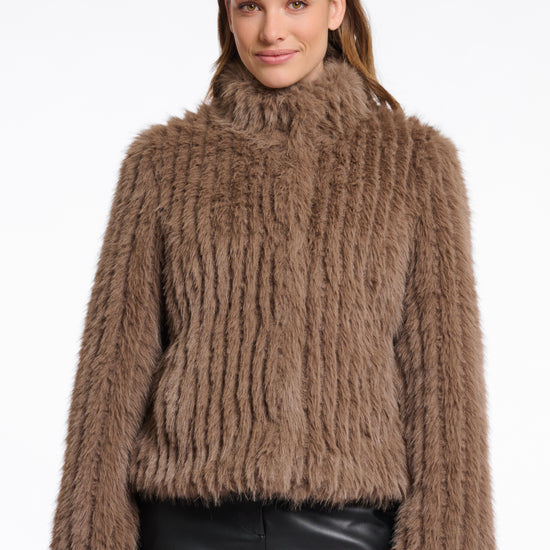 brown faux fur jacket with high neck, central closure and stripe detailing in the fur