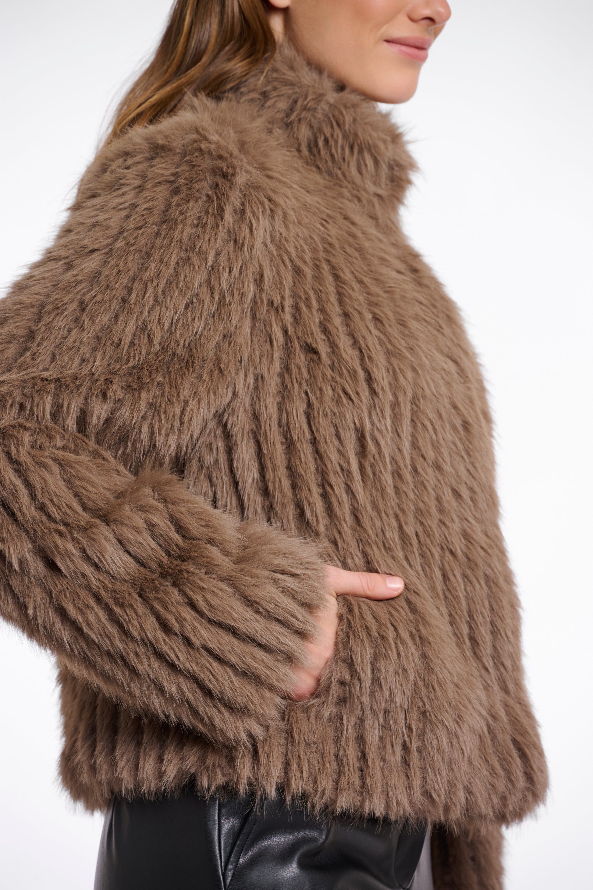 brown faux fur jacket with high neck, central closure and stripe detailing in the fur side view 