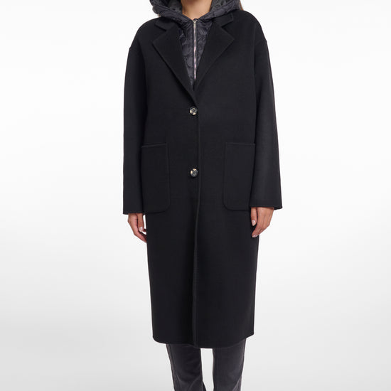 single breasted black coat with interior quilted gilet and 2 patch pockets  model shot