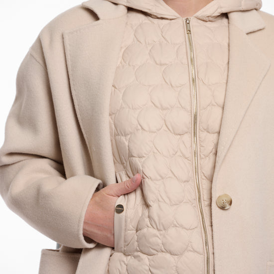 single breasted light beige coat with interior quilted gilet and 2 patch pockets  photo of gilet