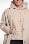 single breasted light beige coat with interior quilted gilet and 2 patch pockets  photo of gilet