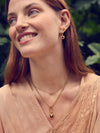 gold pendant heart necklace with red stone from rounded rectangular charm and gold chain from rachel jackson model shot