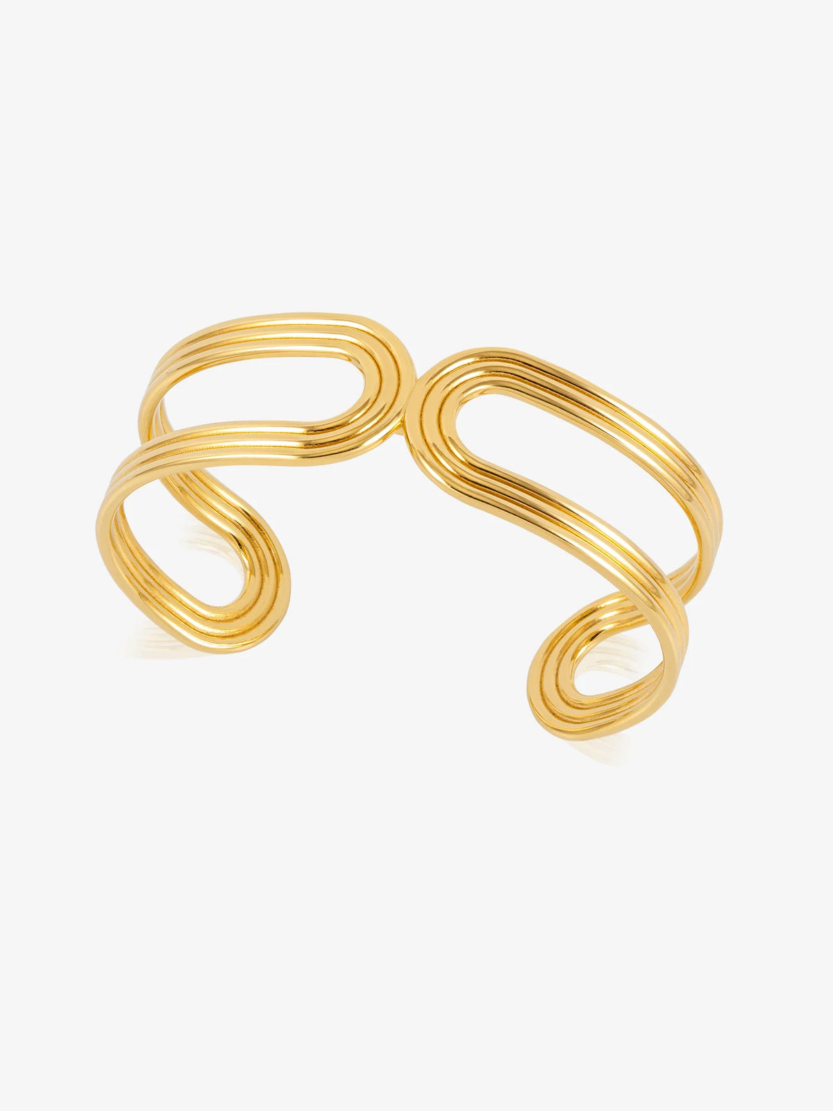A gold-toned metal cuff bracelet with a modern, wavy, multi-layered loop design, shown on a clean white background.