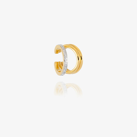 gold and silver ear cuff on white background