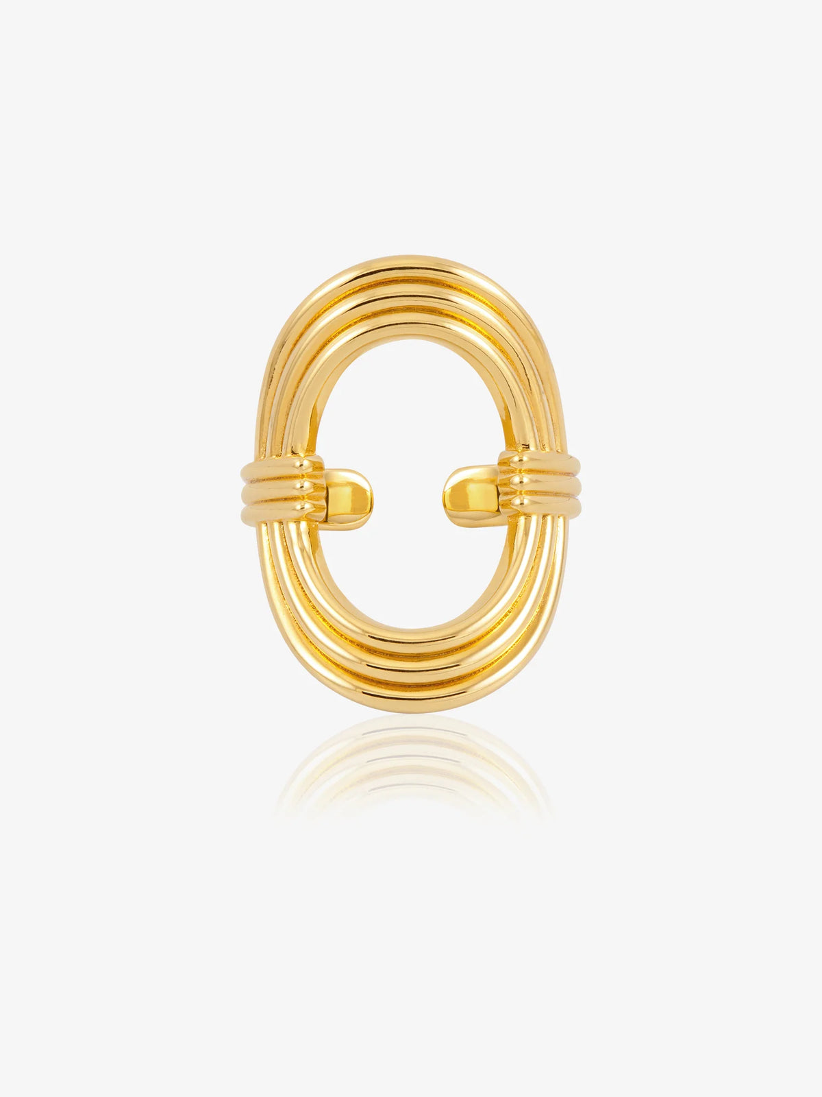 A gold-toned metal ring with a multi-strand oval design and a twisted center detail, shown on a clean white background with a soft reflection below.