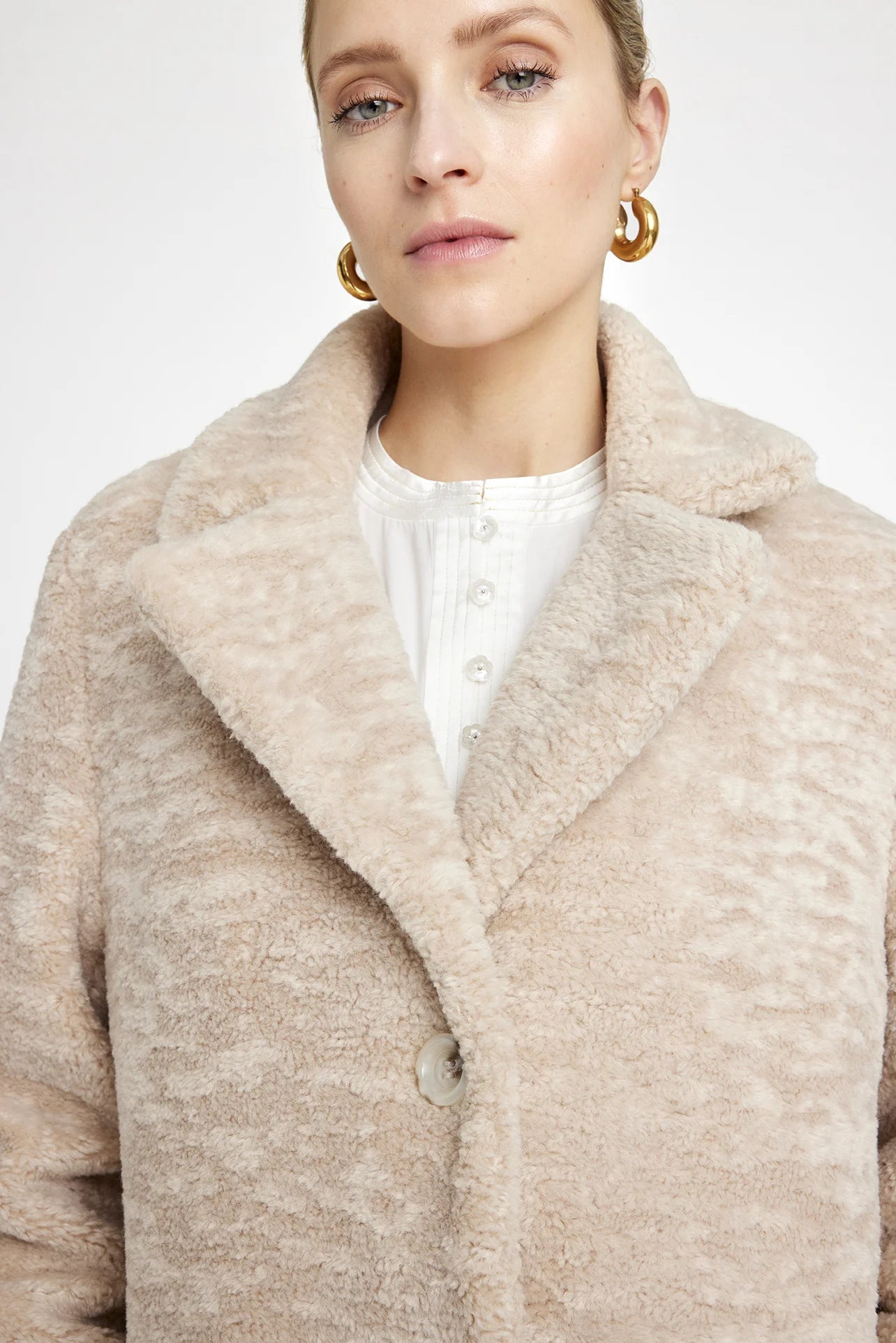 cream faux fur mid length coat close up