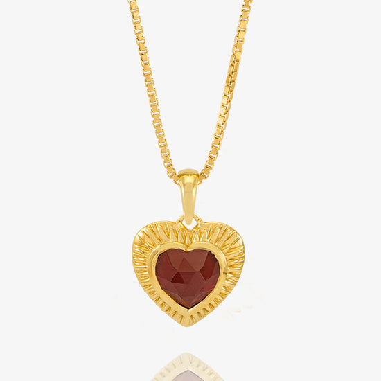 gold heart with red stone inside on a gold chain from rachel jackson