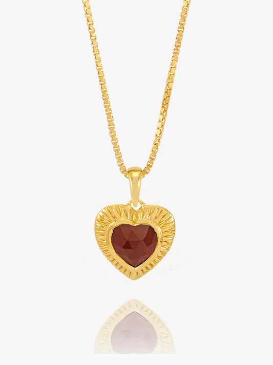gold heart with red stone inside on a gold chain from rachel jackson