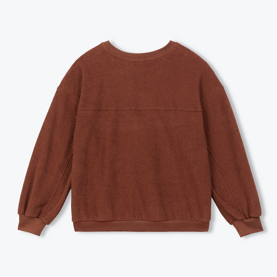A brown crewneck sweatshirt with long balloon sleeves and ribbed cuffs, shown from the back on a light gray background.