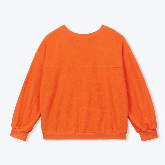 An orange long-sleeve crewneck sweatshirt shown from the back, laid flat against a light gray background.