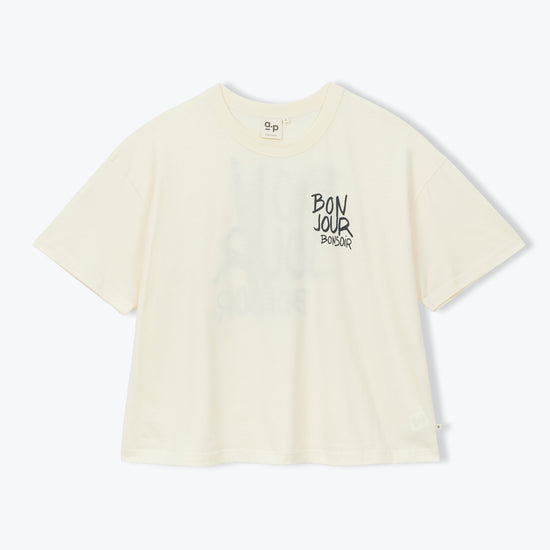 A cream-colored short-sleeve t-shirt with a black graphic text print on the left chest, displayed against a clean white background.