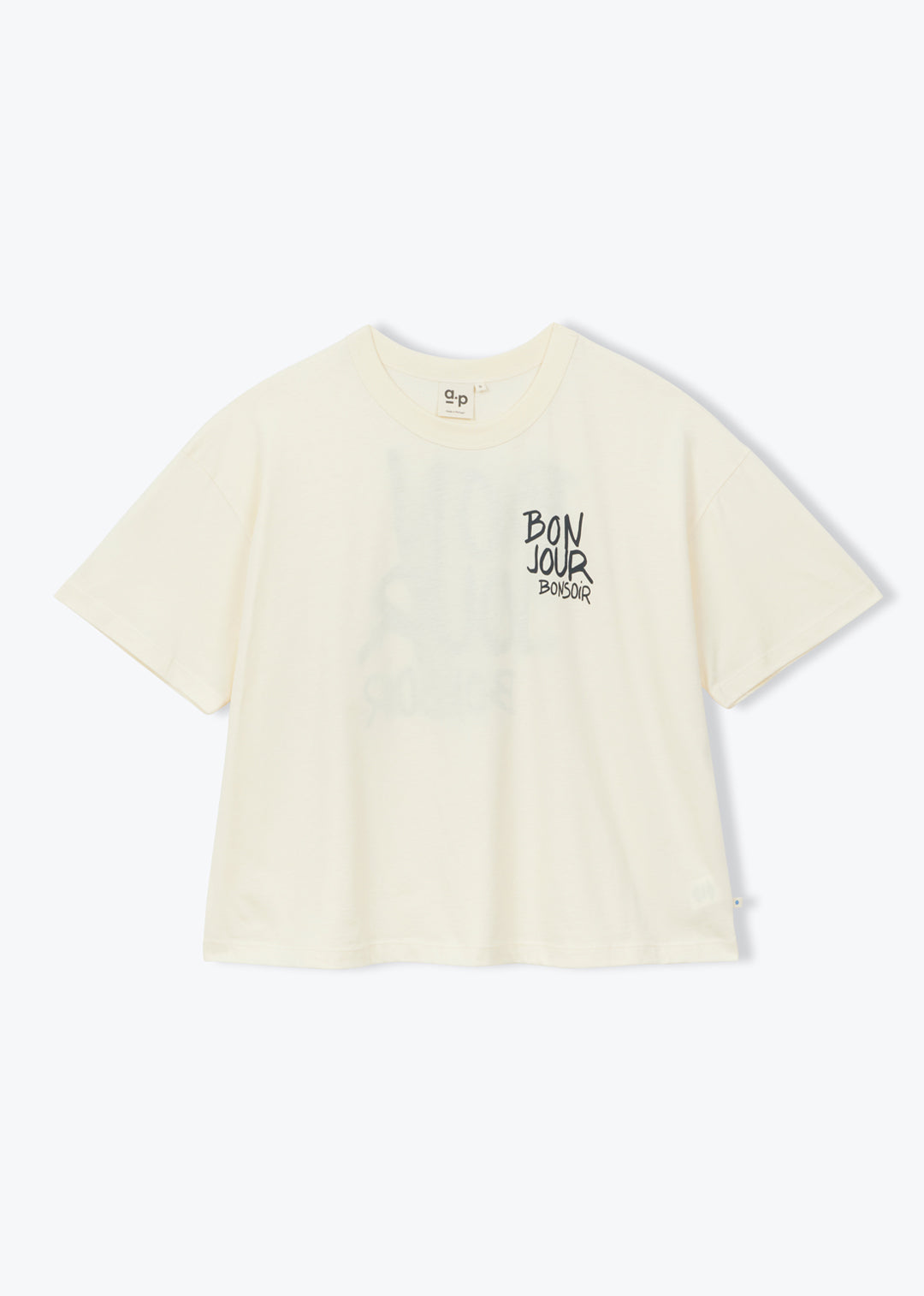 A cream-colored short-sleeve t-shirt with a black graphic text print on the left chest, displayed against a clean white background.