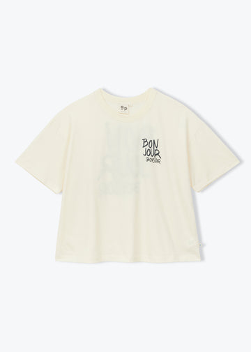 A cream-colored short-sleeve t-shirt with a black graphic text print on the left chest, displayed against a clean white background.