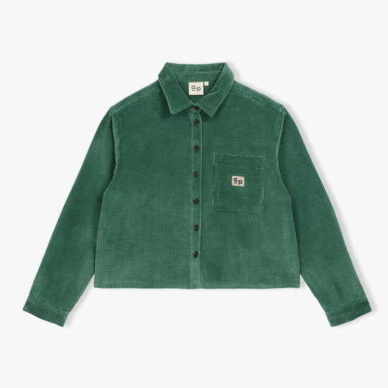 A green corduroy button-up shirt jacket with a chest pocket and a small square logo patch, displayed flat against a light gray background.