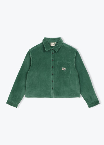 A green corduroy button-up shirt jacket with a chest pocket and a small square logo patch, displayed flat against a light gray background.