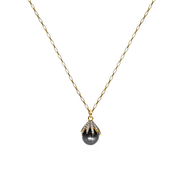 Hematite grey drop necklace held by a pave diamond claw setting on a gold plated belcher chain