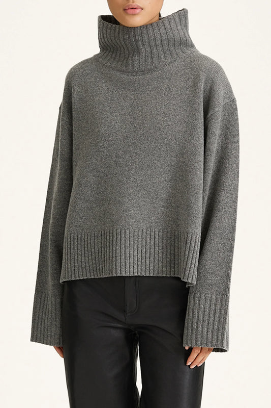 Gray turtleneck sweater worn by a person on a white background