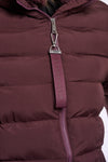 Close-up of a quilted puffer jacket in a deep plum-burgundy color, featuring a silver-tone zipper and a matching fabric pull tab with the brand name 'BENDADETE' printed vertically.
