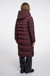 Person wearing a long burgundy puffer coat on a white background