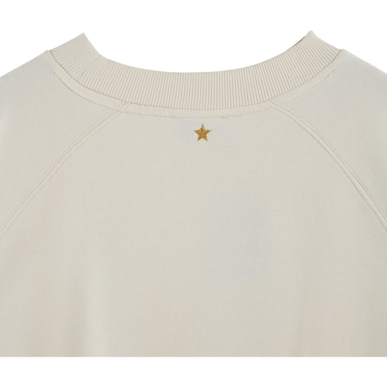 Cream round neck sweatshirt with rib detailing and logo in the centre close up of rear