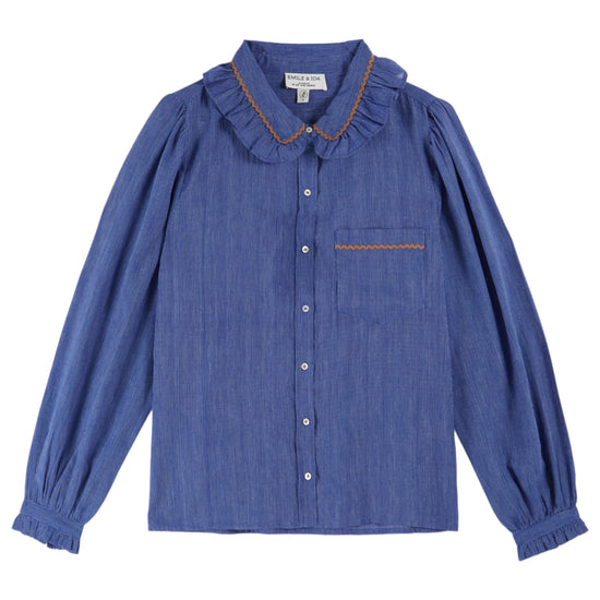 blue blouse with frill collar, chest pocket and elasticated cuffs with orange piping