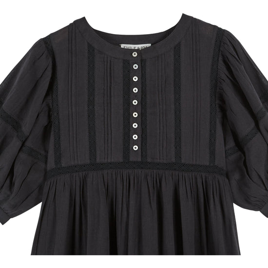 short sleeve mid length black dress with half placket button down from emile and ida  close up