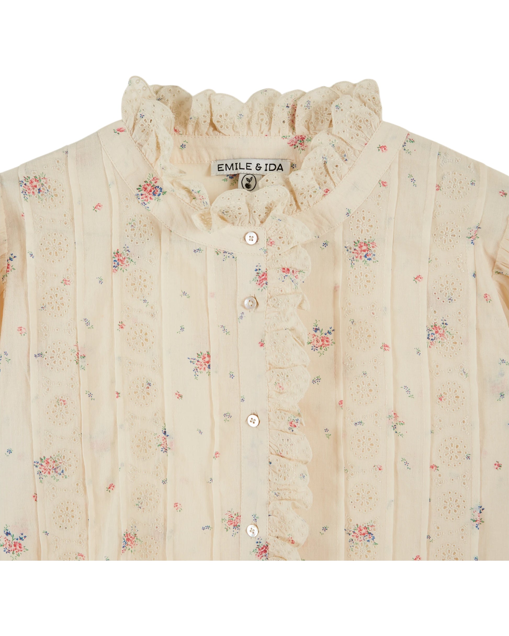 frill stand neck short sleeve pleated button down cream blouse with small floral print throughout from emile and ida close up