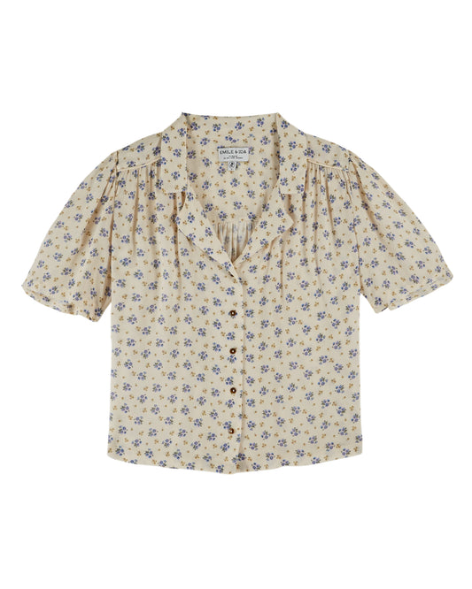 v neck small collar short sleeve cream top with blue floral print throughout from emile and ida