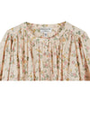 round neck blush pink button down blouse with delicate flower print, pleat detailing and pleated cuffs from emile and ida close up