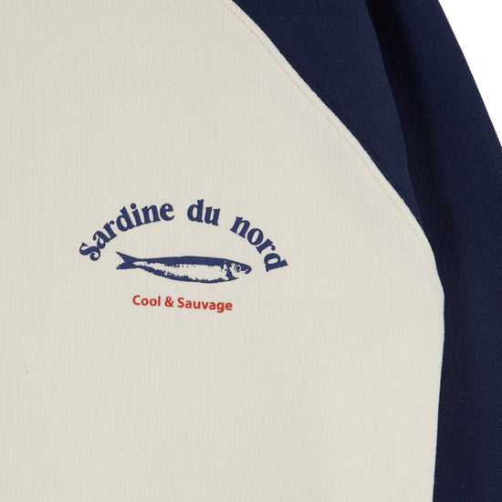 close up of fish detail on blue and white sweatshirt