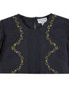 black blouse with flower embroidery on white background close up 