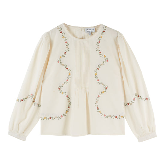 cream blouse with flower embroidery on white background