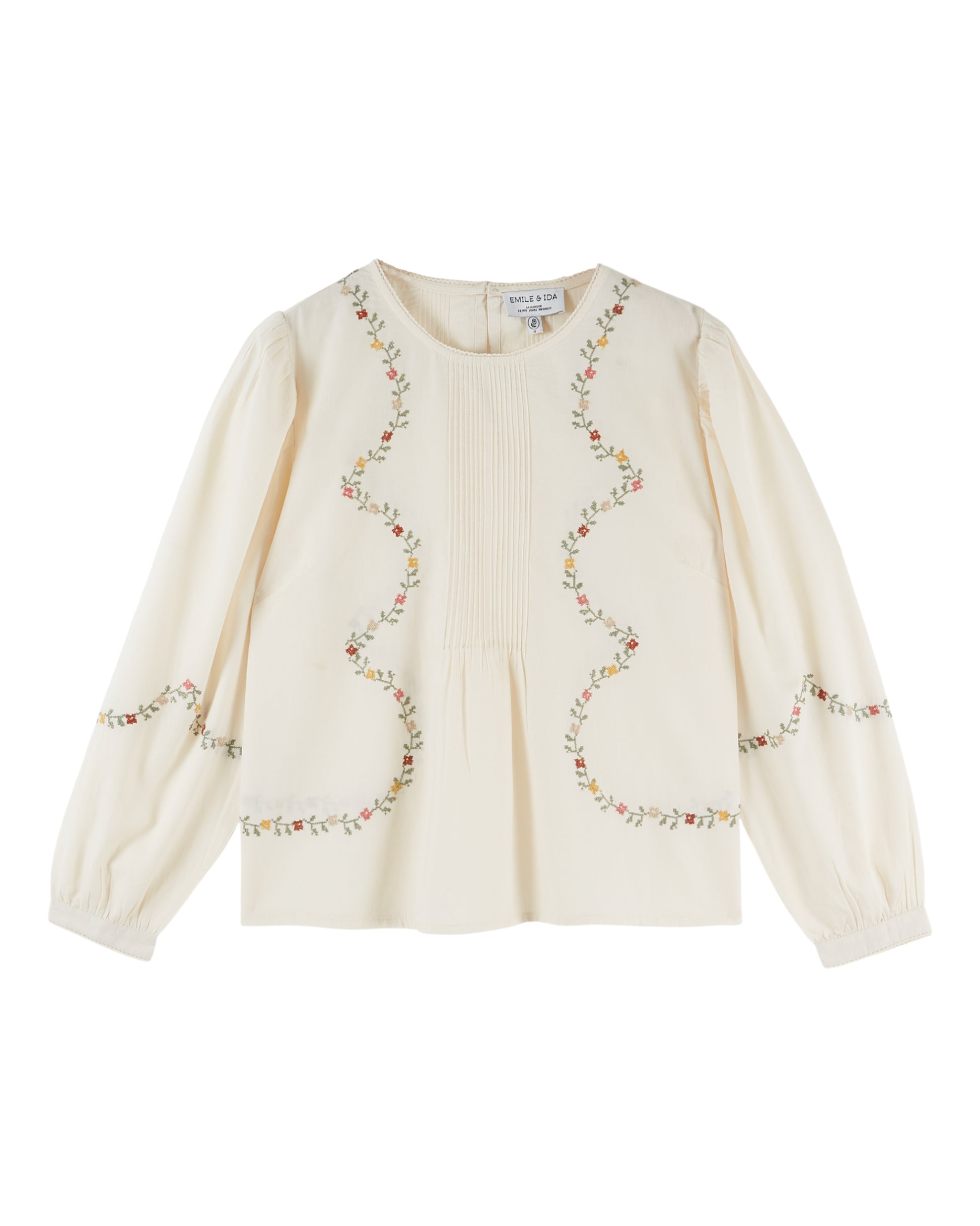 cream blouse with flower embroidery on white background