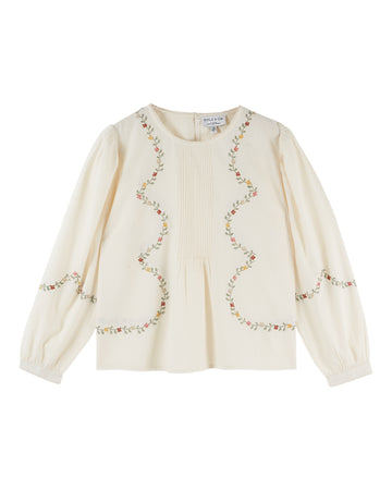 cream blouse with flower embroidery on white background