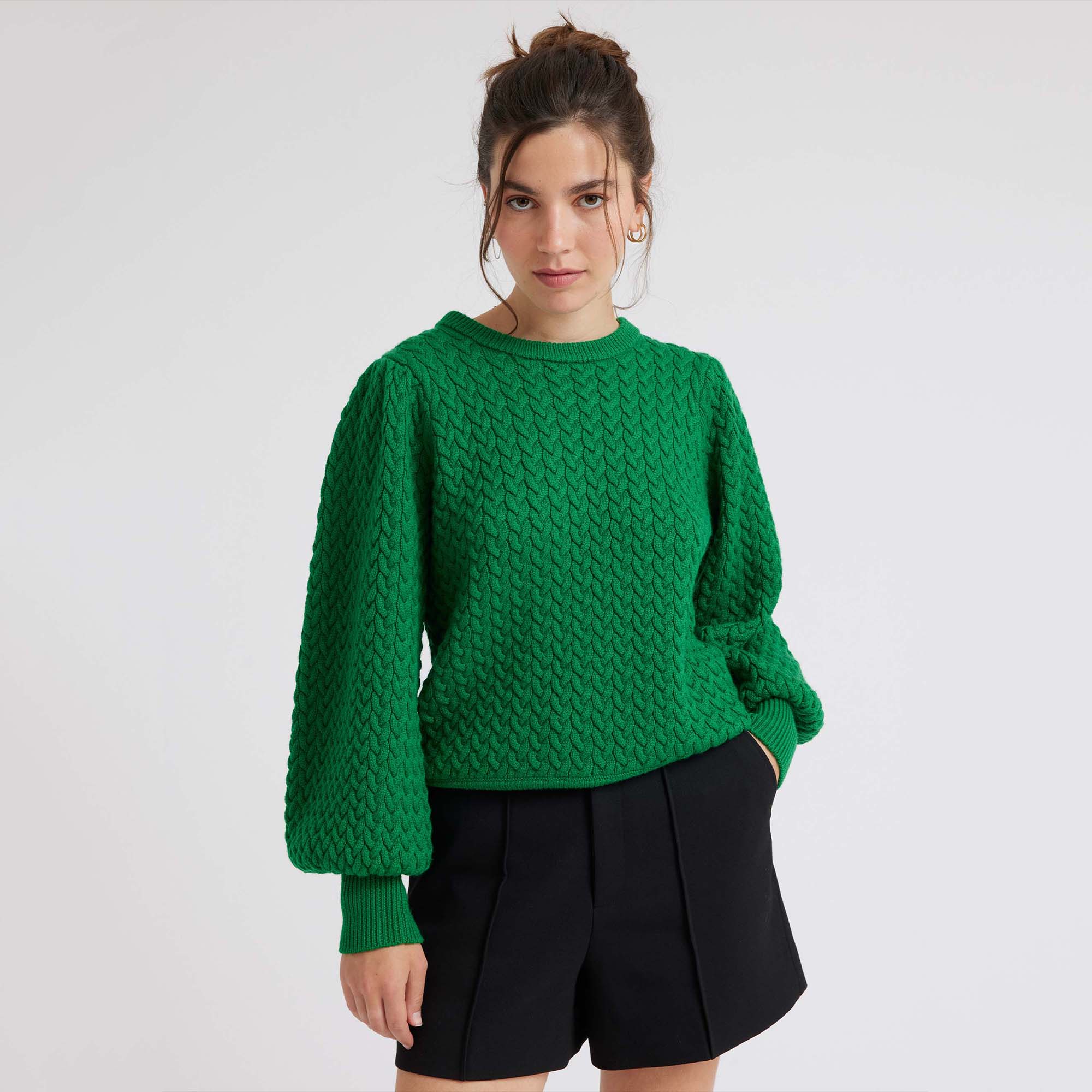 Green round neck jumper with long ballon sleeves in a cable stitch