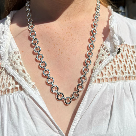 silver donut style chain necklace model shot close up