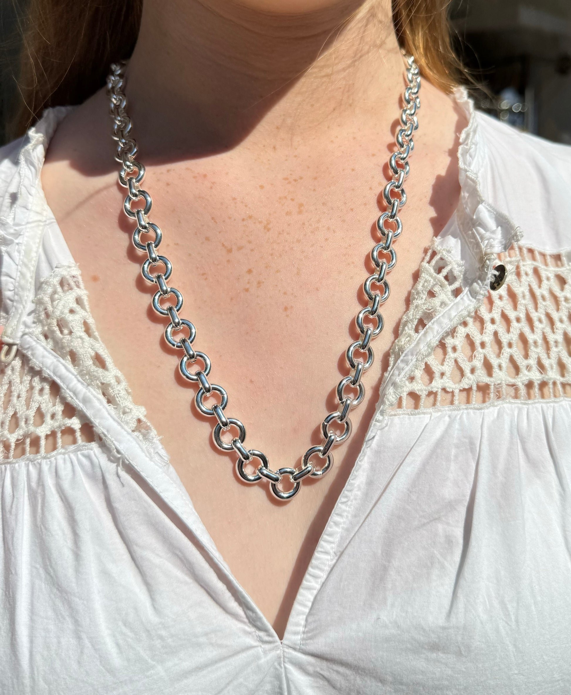 silver donut style chain necklace model shot close up