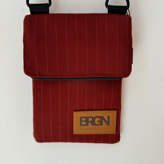 red pinstripe waterproof messenger bag with cross body strap