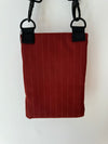 red pinstripe waterproof messenger bag with cross body strap rear view