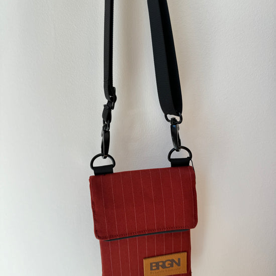 red pinstripe waterproof messenger bag with cross body strap