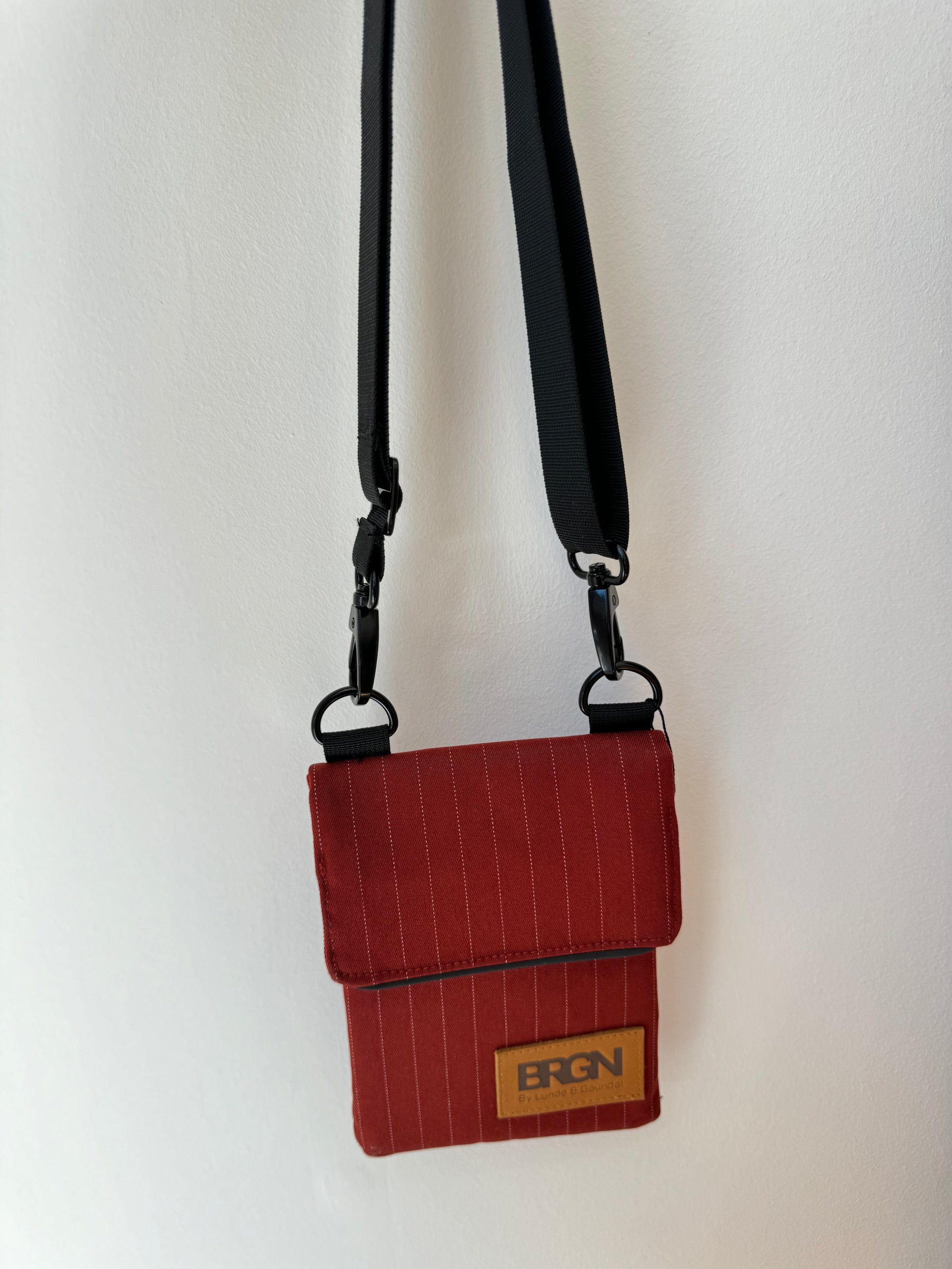 red pinstripe waterproof messenger bag with cross body strap