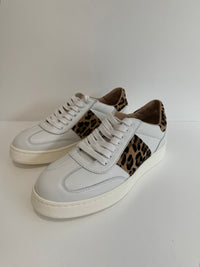 Front view of white leather trainers with animal print details